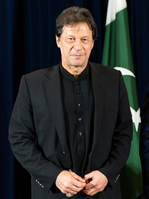 Imran Khan in a black suit and black shirt